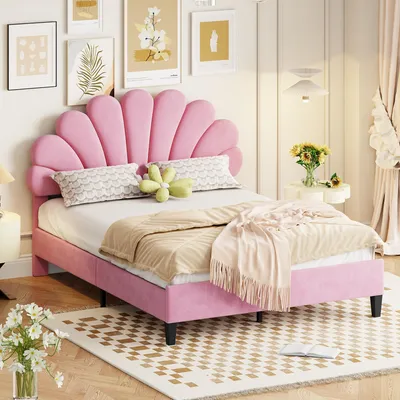 A pink upholstered bed with a shell-shaped headboard in a bedroom setting.