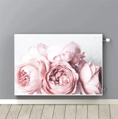 A radiator cover with a pink floral print is shown mounted on a gray wall above a wooden floor.