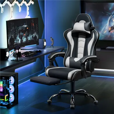 A gaming chair is set up in a modern gaming room with a computer, monitor, and ambient lighting.