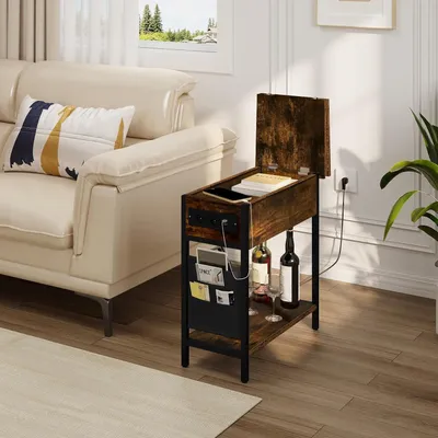 A vintage-style side table with a charging station is placed next to a cream-colored sofa in a living room.