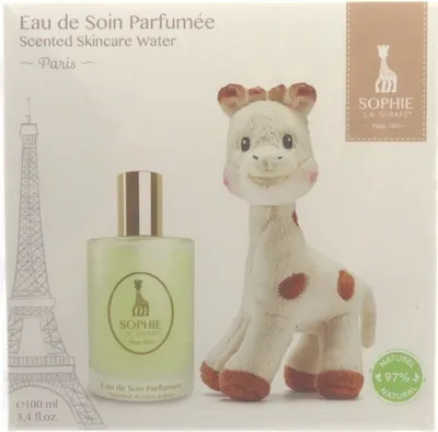 A gift set featuring a bottle of scented skincare water and a Sophie La Girafe toy, with an illustration of the Eiffel Tower.