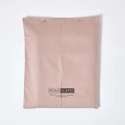 A folded beige textile product, likely a sheet or duvet cover, laid flat against a white wall.