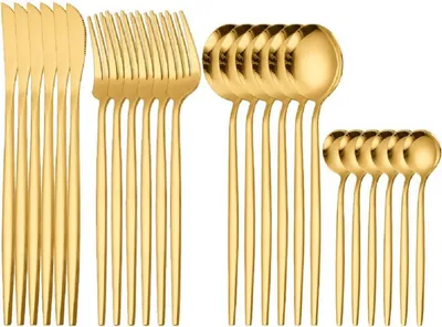 A set of gold-colored cutlery, including knives, forks, and spoons, arranged neatly.