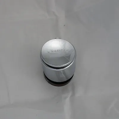A close-up shot of a chrome-plated temperature selection knob for a faucet.