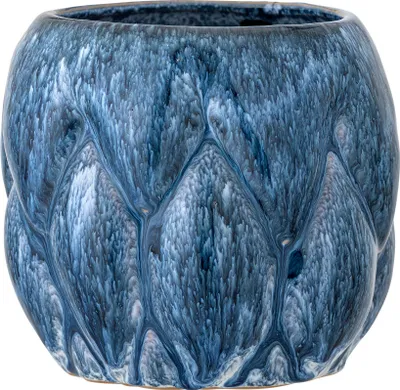 A close-up studio shot of a blue ceramic pot with a textured, drippy glaze.