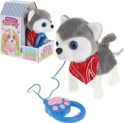 A plush husky dog toy with a leash and a box in the background.
