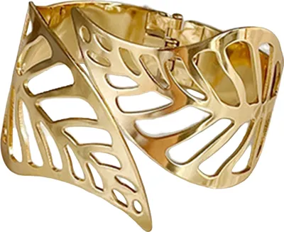 A close-up studio shot of a gold-colored cuff bracelet with a leaf or feather-like cutout design.