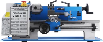 A blue and gray mini metal lathe is shown against a white background. The lathe has various controls and a label with specifications.