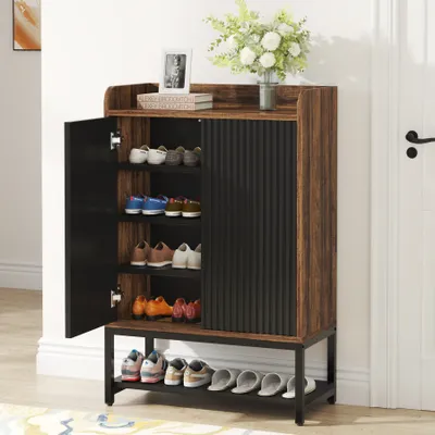 A shoe cabinet with its door open, displaying shoes on shelves, placed in a hallway next to a white door.