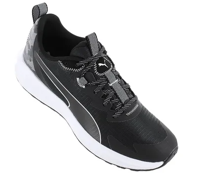 A studio shot of a black Puma sneaker with a white sole.