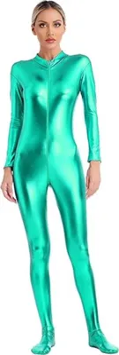 A woman is standing and posing in a full-body metallic green jumpsuit.