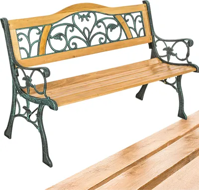 A garden bench with wooden slats and ornate green metalwork.