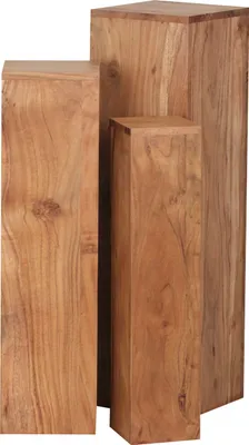 Three wooden pedestals of varying heights are arranged together.