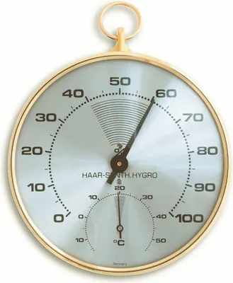 A close-up studio shot of a round analog thermo-hygrometer with a brass ring for hanging.