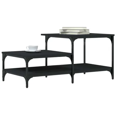 A dark, multi-tiered coffee table with a white cup and saucer on the lower tier and a stack of books on the upper tier.