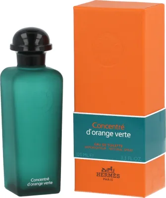 A bottle of Hermes Concentré D'Orange Verte Eau de Toilette and its packaging are displayed against a white background.
