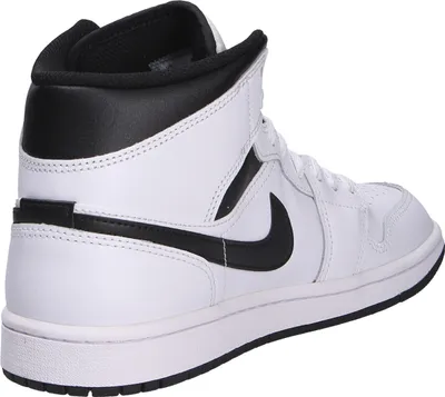 A side view of a white Nike Air Jordan 1 Mid sneaker with black accents.