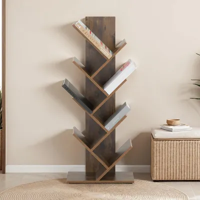 A brown tree-shaped bookshelf with books on it, placed on a rug in front of a wall.