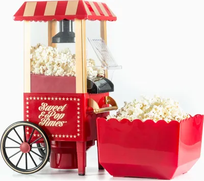 A red and gold popcorn machine with a tub of popcorn next to it, on a white background.