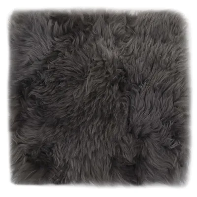 A close-up view of a gray sheepskin cushion.