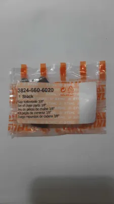 A sealed plastic package containing chainsaw parts.