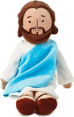 A plush doll of Jesus sitting down.