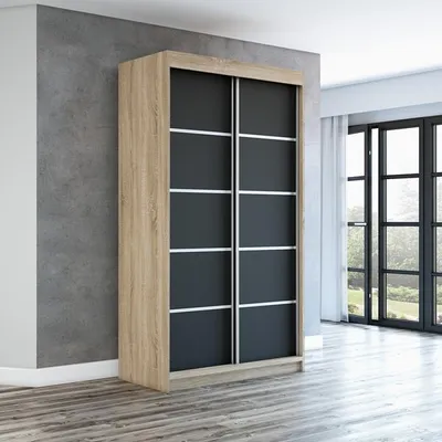 A modern wardrobe with sliding doors in a room with a concrete wall and wooden floor.