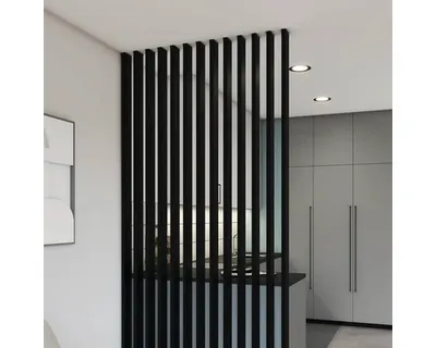 A modern interior with a black slatted room divider.