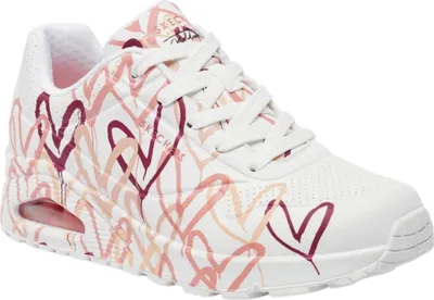 A single white sneaker with a heart pattern.