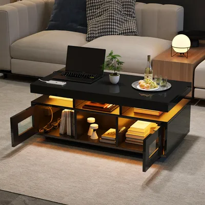 A modern black coffee table with LED lighting is placed in a living room setting next to a sofa.