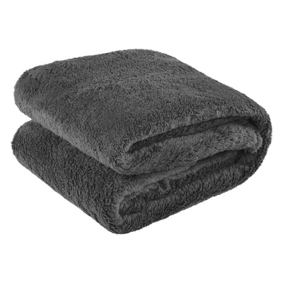 A folded gray fleece blanket.