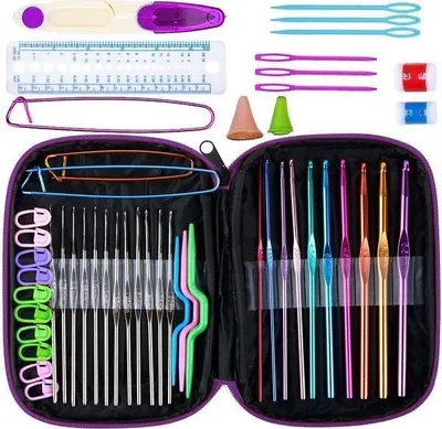 A crochet hook set laid out in a purple case, with various accessories scattered around.
