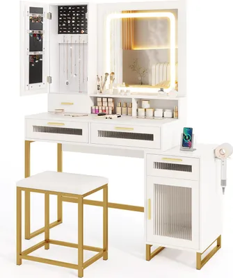 A white vanity table set with a lighted mirror, jewelry cabinet, drawers, a stool, and a side cabinet.