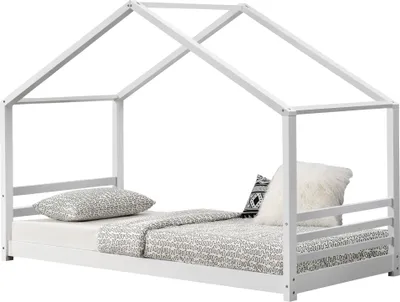 A white house-shaped bed frame with bedding and pillows.