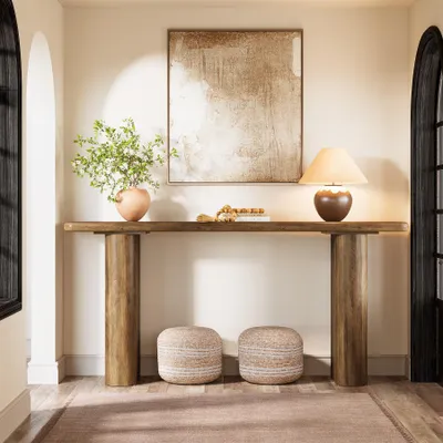 A console table with decor in a hallway.