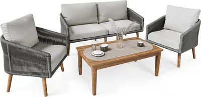 A set of outdoor furniture including a sofa, two chairs, and a coffee table, arranged on a white background.
