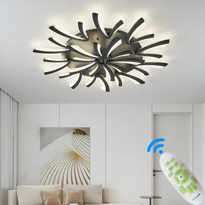 A modern living room with a ceiling light and a remote control.