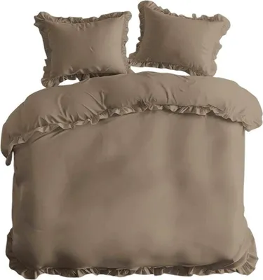 A taupe colored duvet cover and two pillowcases with ruffles, laid out on a white background.