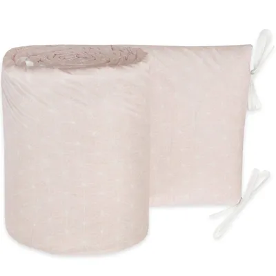 A rolled-up baby crib bumper with a geometric pattern.