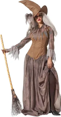 A woman in a witch costume holding a broom.