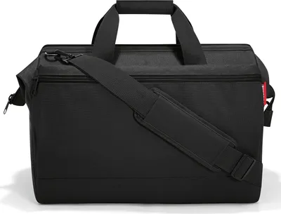A studio shot of a black duffel bag.