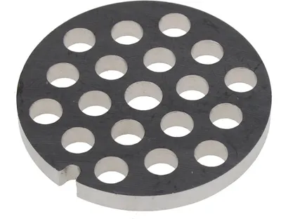A close-up, isolated shot of a meat grinder plate with multiple holes.