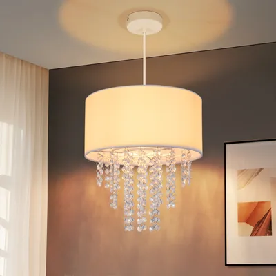 A pendant light fixture with a fabric shade and crystal accents hangs from the ceiling.