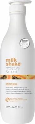 A white bottle of Milk_Shake Moisture & More Shampoo with orange and yellow fruit imagery on the label.