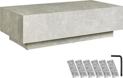 A rectangular coffee table with a stone-like pattern and a set of floor protectors and an Allen wrench.