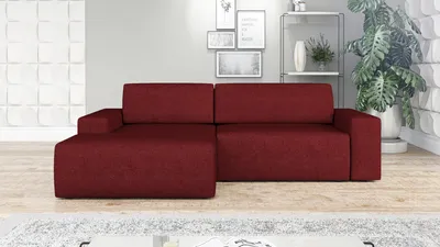 A red sectional sofa is shown in a living room setting with decorative elements on the wall and a plant in the background.