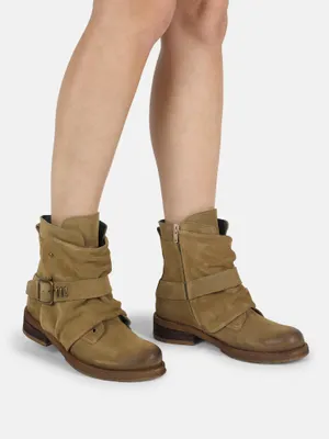 A pair of women's ankle boots worn by a person.