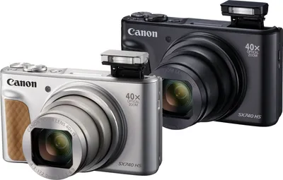 Two Canon PowerShot SX740 HS cameras, one silver and one black, are shown against a white background.