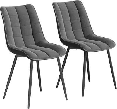 Two dark gray upholstered dining chairs with black metal legs are shown against a white background.