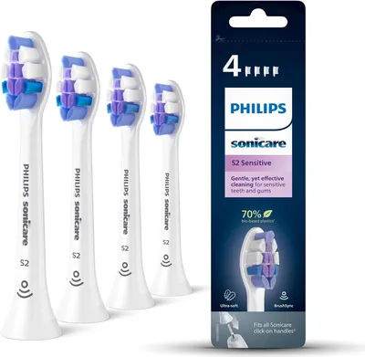 Four Philips Sonicare S2 Sensitive toothbrush heads are displayed next to their packaging.